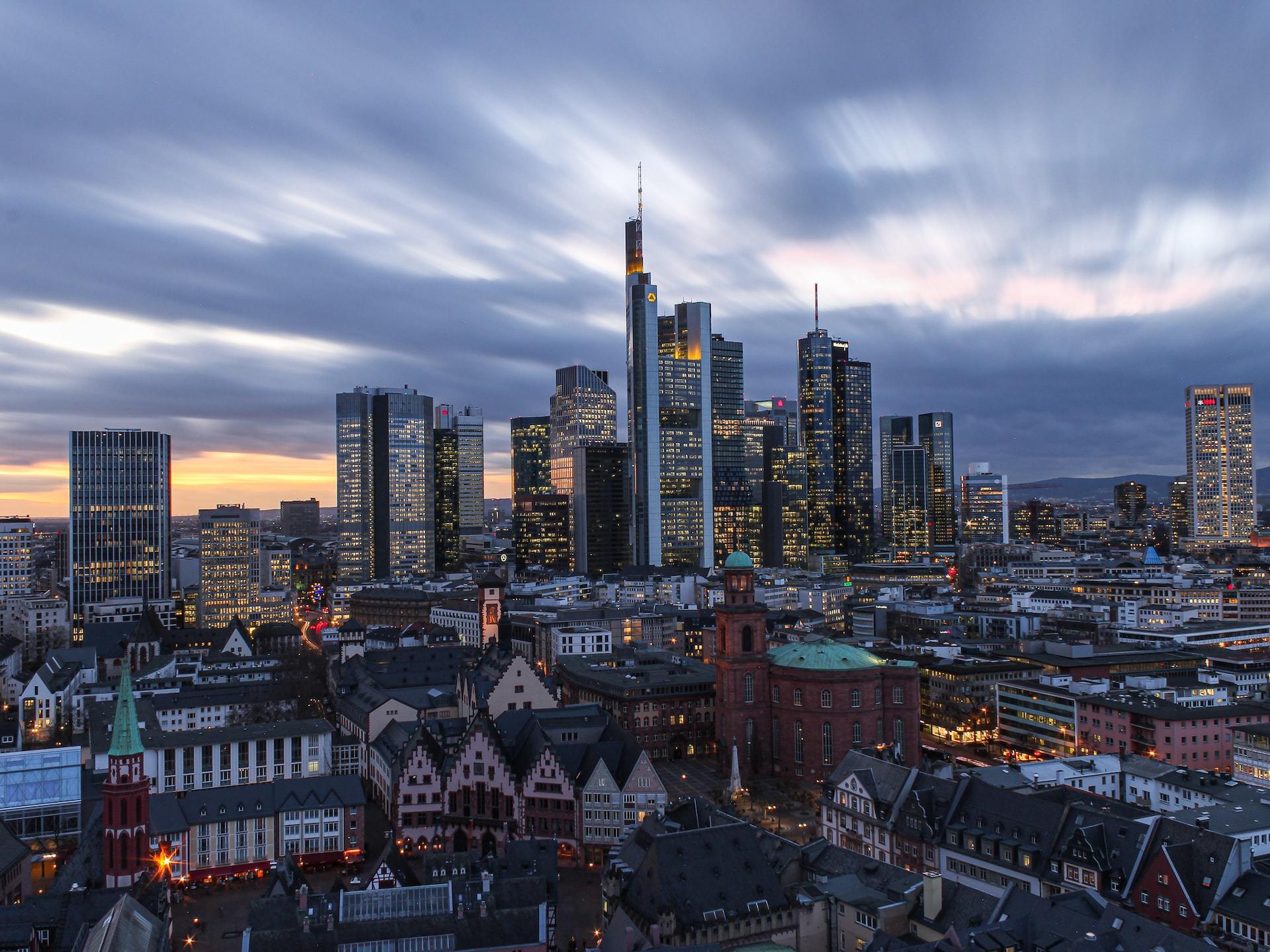 Frankfurt's city skyline under white clouds.